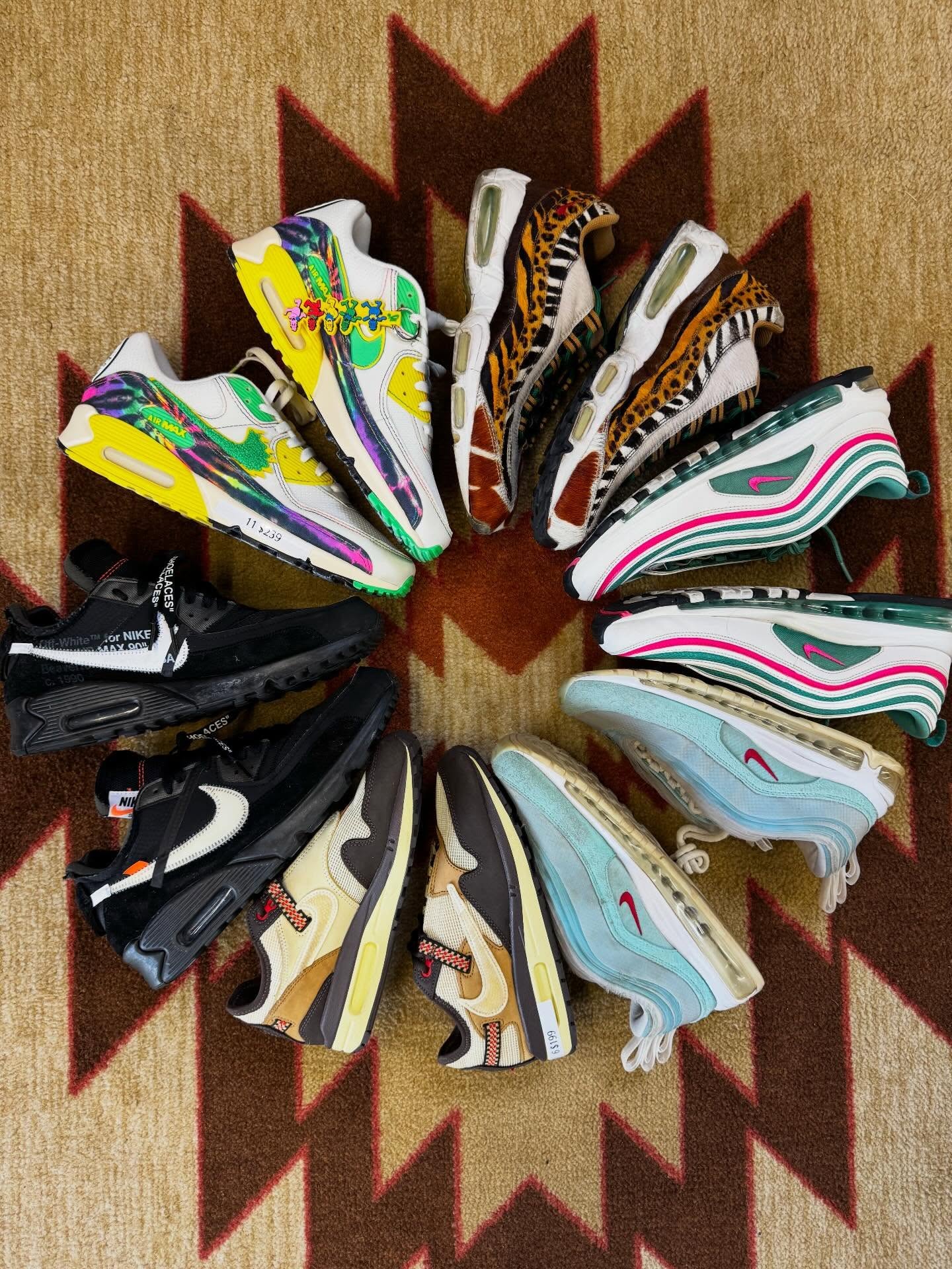Colorful sneakers arranged in a circular pattern on a textured surface